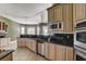 Kitchen featuring stainless steel appliances, a breakfast bar and tile floors at 12780 Davis Wright Ct, Henderson, NV 89044