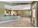 Open-concept living room and kitchen with tile flooring and modern lighting at 12780 Davis Wright Ct, Henderson, NV 89044