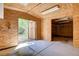 Backyard shed featuring wood paneling, lighting, shelving, and a cement floor at 12780 Davis Wright Ct, Henderson, NV 89044