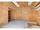 Interior view of a backyard shed with wood paneling, lighting and shelving at 12780 Davis Wright Ct, Henderson, NV 89044