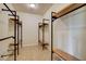 Spacious walk-in closet with custom wood shelving and metal bars at 12780 Davis Wright Ct, Henderson, NV 89044