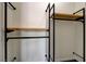 Another view of a functional walk-in closet with custom shelving and metal bars at 12780 Davis Wright Ct, Henderson, NV 89044