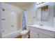 Bright bathroom featuring a shower-tub combination, a vanity with storage, and a patterned shower curtain at 1316 Capri Dr # Abc&D, Boulder City, NV 89005