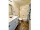 Updated bathroom featuring a white vanity, shower-tub combination with a patterned curtain, and neutral accents at 1316 Capri Dr # Abc&D, Boulder City, NV 89005