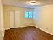 Cozy bedroom with wood floors, a window, and a closet perfect for relaxation at 1316 Capri Dr # Abc&D, Boulder City, NV 89005