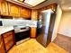 Well-lit kitchen featuring stainless steel appliances, tile flooring, and ample wood cabinetry for storage at 1316 Capri Dr # Abc&D, Boulder City, NV 89005