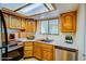 Bright kitchen featuring wooden cabinets, stainless steel appliances, and a window with natural light at 1316 Capri Dr # Abc&D, Boulder City, NV 89005