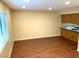 Bright living room with wood floors and a window with a kitchen in the background at 1316 Capri Dr # Abc&D, Boulder City, NV 89005