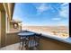 Private balcony with a table and chairs overlooking the desert landscape at 15 Via Mantova # 401, Henderson, NV 89011