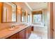 Elegant bathroom with double sinks, a makeup vanity, and luxurious soaking tub and shower at 15 Via Mantova # 401, Henderson, NV 89011