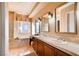 Bright bathroom offers double sinks, large mirrors, bathtub, and tiled walk-in shower at 15 Via Mantova # 401, Henderson, NV 89011