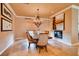 Elegant dining room with a stylish chandelier, travertine flooring, and modern decor at 15 Via Mantova # 401, Henderson, NV 89011