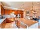 Spacious kitchen features granite countertops, stainless steel appliances, and large center island with dining area at 15 Via Mantova # 401, Henderson, NV 89011
