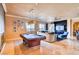 Spacious living room featuring a billiards table, comfortable seating, and a built-in entertainment center at 15 Via Mantova # 401, Henderson, NV 89011