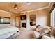 This spacious primary bedroom includes a fireplace, lounge area, and large windows for natural light at 15 Via Mantova # 401, Henderson, NV 89011