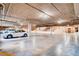 A well-lit, spacious parking garage with painted parking spots and a concrete ceiling at 15 Via Mantova # 401, Henderson, NV 89011