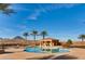 Enjoy this backyard pool featuring a pool house and palm trees set against the backdrop of desert mountains at 15 Via Mantova # 401, Henderson, NV 89011