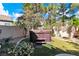 Backyard featuring a jacuzzi with surrounding green grass, palm trees and partial shade at 1825 Derbyshire Dr, Las Vegas, NV 89117
