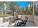 Outdoor balcony with seating overlooking a view of trees and greenery for relaxation and enjoyment at 1825 Derbyshire Dr, Las Vegas, NV 89117