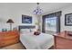 Cozy bedroom with a plush bed, soft lighting, and neutral decor for a comfortable retreat at 1825 Derbyshire Dr, Las Vegas, NV 89117