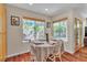 Bright dining area with hardwood floors, natural light, and garden views, perfect for Gathering meals at 1825 Derbyshire Dr, Las Vegas, NV 89117