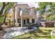 Exterior view of home, patio with dining set, artificial grass and hot tub at 1825 Derbyshire Dr, Las Vegas, NV 89117