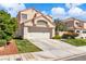 Inviting two-story home featuring a two-car garage, xeriscaped front yard, and a tile roof at 1825 Derbyshire Dr, Las Vegas, NV 89117