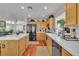 Spacious kitchen with island, black appliances, hardwood floors and view to the living room at 1825 Derbyshire Dr, Las Vegas, NV 89117