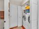 Convenient laundry room with modern appliances, including a washer, dryer, and extra storage at 1825 Derbyshire Dr, Las Vegas, NV 89117