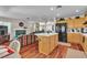 Inviting open-concept living area with hardwood floors, fireplace, and seamless flow into the kitchen at 1825 Derbyshire Dr, Las Vegas, NV 89117