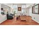 Open-concept living room features hardwood floors, neutral paint, and a cozy seating area at 1825 Derbyshire Dr, Las Vegas, NV 89117