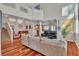 Open-concept living room with hardwood floors, large windows, and staircase leading to the second story at 1825 Derbyshire Dr, Las Vegas, NV 89117