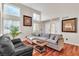 Bright living room with high ceilings, natural light, hardwood floors, and a comfortable sectional sofa at 1825 Derbyshire Dr, Las Vegas, NV 89117