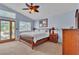 Serene main bedroom features high ceilings, outdoor access, and classic wood furniture at 1825 Derbyshire Dr, Las Vegas, NV 89117