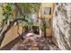 Landscaped side yard with stone walkway, decorative rocks, desert flora and stucco wall for added privacy at 1825 Derbyshire Dr, Las Vegas, NV 89117