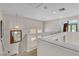 Bright upstairs landing with carpeted stairs, pendant lighting, and decorative mirror on the wall at 1825 Derbyshire Dr, Las Vegas, NV 89117