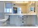Bathroom with a large mirror, double sinks, and neutral tile at 189 Regal Sunset Ave, Henderson, NV 89002
