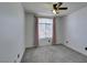 Bedroom with a large window, pink curtains, and neutral carpet at 189 Regal Sunset Ave, Henderson, NV 89002