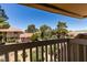 Balcony view of complex units surrounded by lush trees under a blue sky at 2454 Paradise Village Way, Las Vegas, NV 89120
