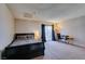 A neutral bedroom features soft carpet, a queen bed, desk, and a sliding glass door for natural light at 2454 Paradise Village Way, Las Vegas, NV 89120