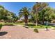 Well-maintained community lawn with mature trees, shrubs and pathways, and building exteriors on a sunny day at 2454 Paradise Village Way, Las Vegas, NV 89120