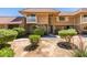Two-story townhome showcasing manicured bushes, and a tiled roof at 2454 Paradise Village Way, Las Vegas, NV 89120