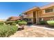 Manicured lawn with plants outside of townhomes that boast clean lines, and neutral color at 2454 Paradise Village Way, Las Vegas, NV 89120