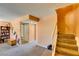 Upstairs hallway area displaying carpet, stairs, geometric wall art, and access to the bathroom at 2454 Paradise Village Way, Las Vegas, NV 89120