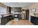 Kitchen featuring stainless steel appliances and dark cabinets with wood-look floors at 2454 Paradise Village Way, Las Vegas, NV 89120