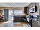 Kitchen area with stainless steel appliances and black cabinets with natural light at 2454 Paradise Village Way, Las Vegas, NV 89120