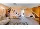 Living room with carpet, neutral walls, geometric paint, a stairway, and view into the dining room at 2454 Paradise Village Way, Las Vegas, NV 89120