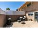 Back patio area with hardscape, fencing, and outdoor furniture provides a private retreat for relaxation at 2454 Paradise Village Way, Las Vegas, NV 89120
