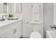Bright bathroom featuring white cabinets, mirror, sink, and toilet at 2559 Winterwood Blvd, Las Vegas, NV 89142