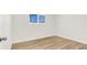 Bright bedroom features light wood flooring and a window with security bars at 2559 Winterwood Blvd, Las Vegas, NV 89142